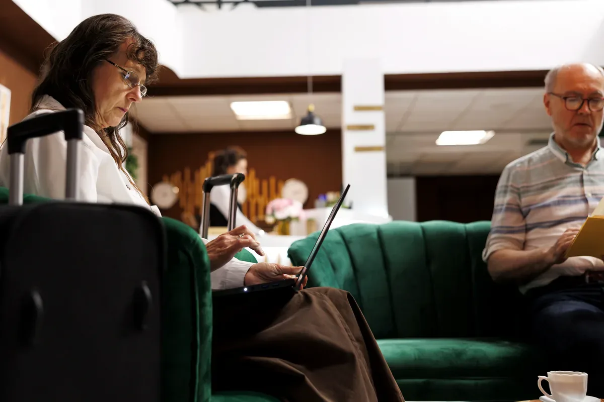 Personas mayores que esperan sentadas en una sala con sus papeles